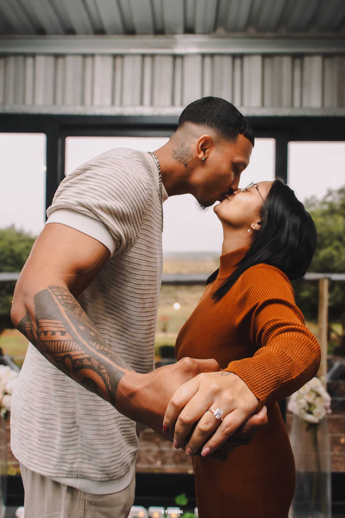 Couple embracing outdoors with a blurred background